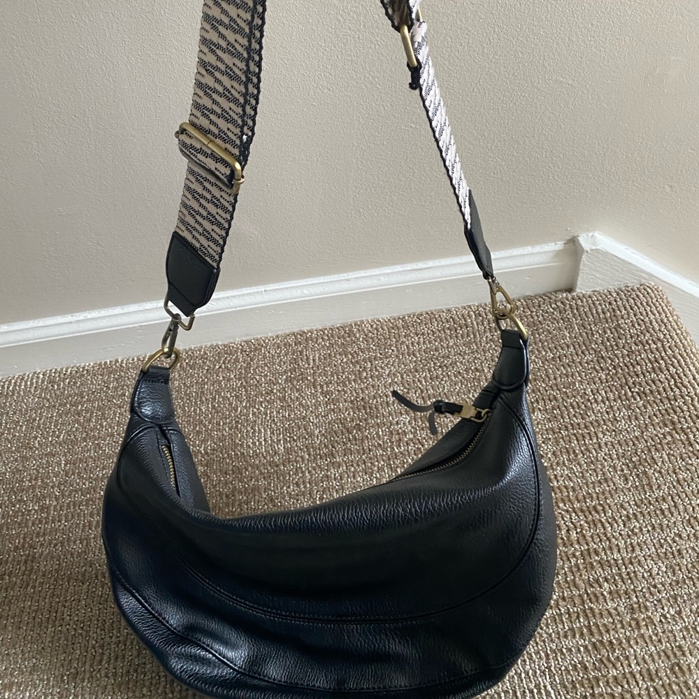 Black leather crossbody bag from Anthropologie.